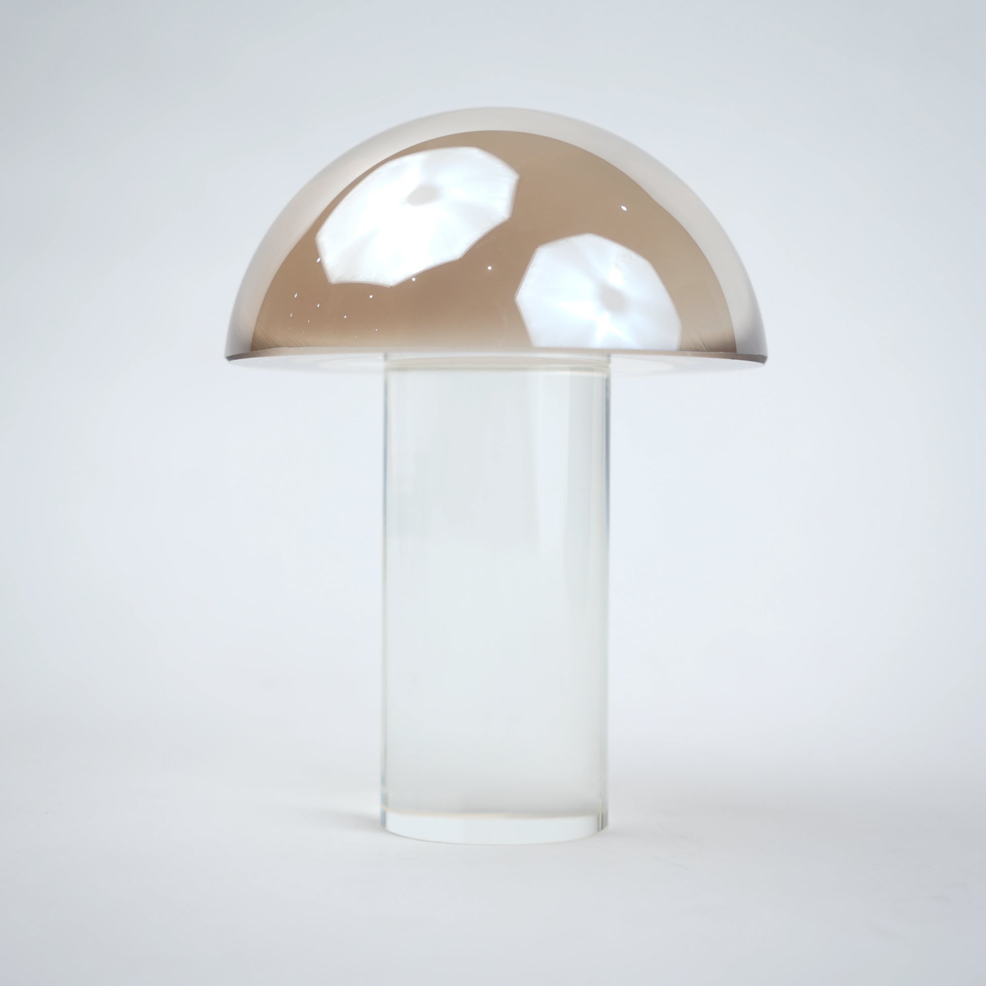Mushroom-shaped lamp with gold top and clear base 