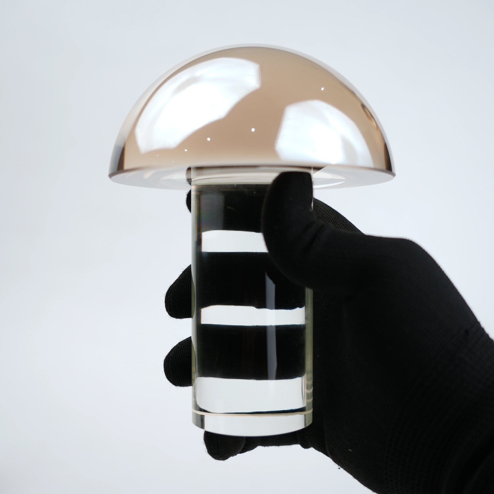 Mushroom-shaped lamp with gold top and clear base 