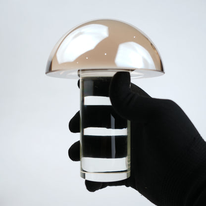 Mushroom-shaped lamp with gold top and clear base 