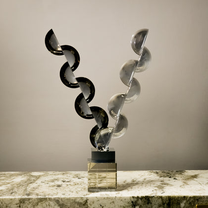 Designer geometric tabletop accent featuring transparent and smoked acrylic elements in a modern luxury interior