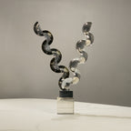 Artistic contemporary decor accent with balanced geometric acrylic forms showcased on a marble countertop setting