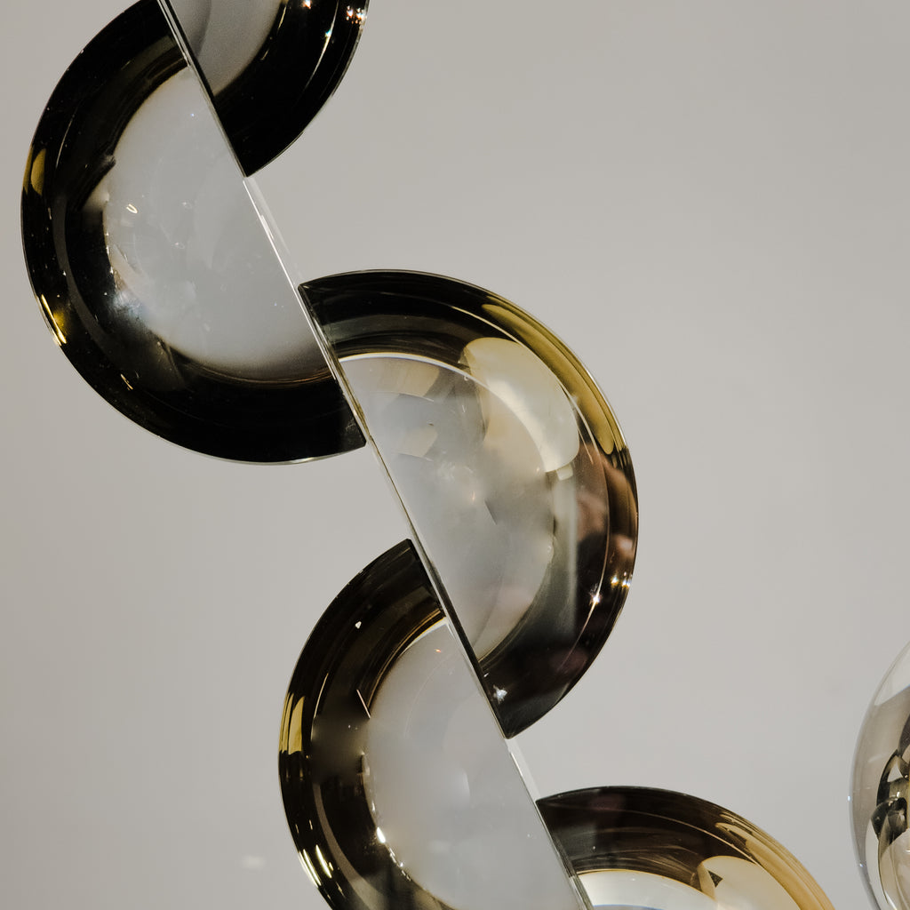 Contemporary acrylic decor piece crafted with artistic curved shapes for upscale shelf and console arrangements