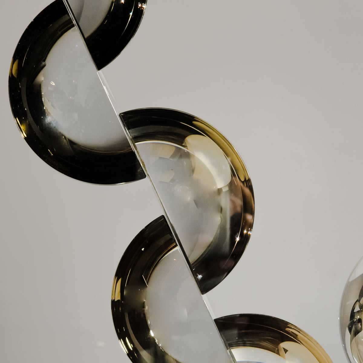 Contemporary acrylic decor piece crafted with artistic curved shapes for upscale shelf and console arrangements