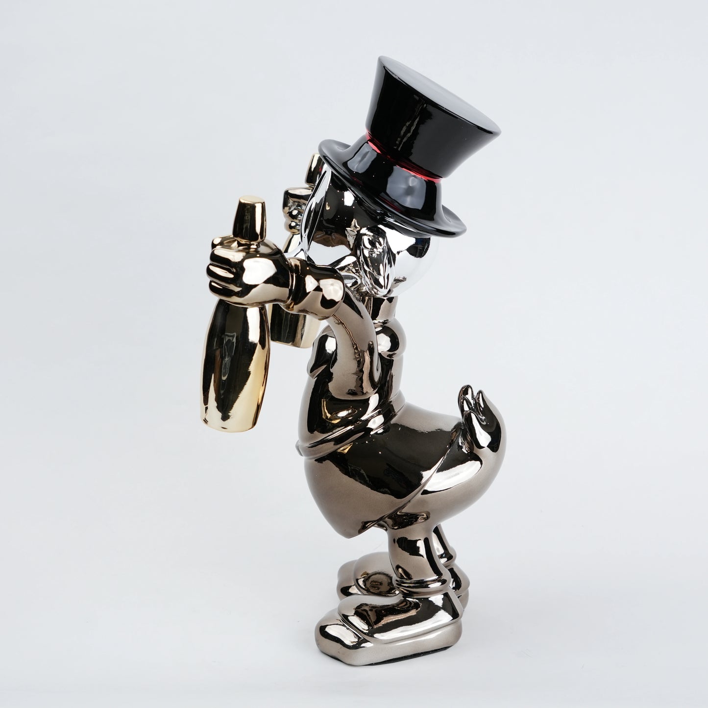 metallic duck figurine holding champagne bottles modern quirky home decor