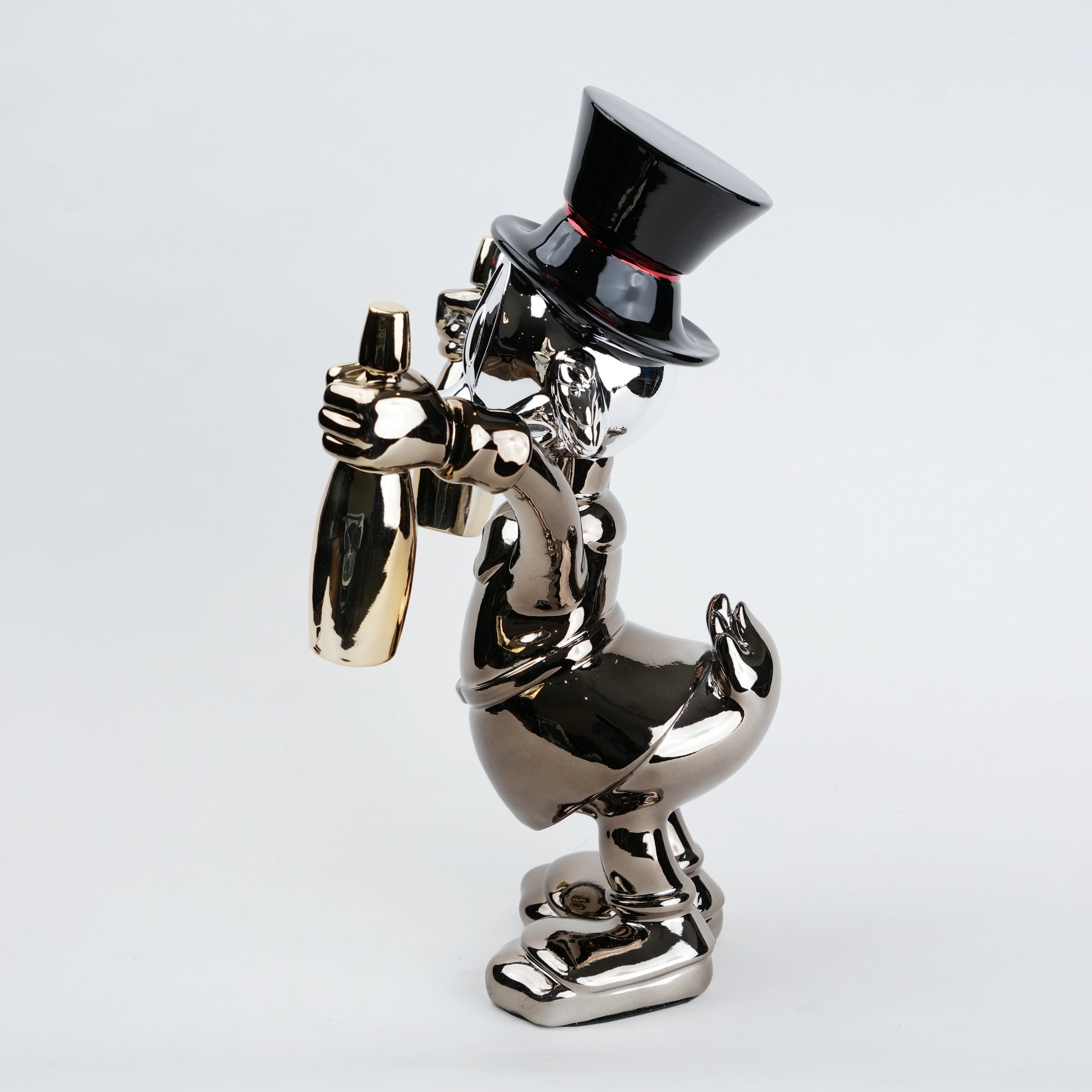 metallic duck figurine holding champagne bottles modern quirky home decor