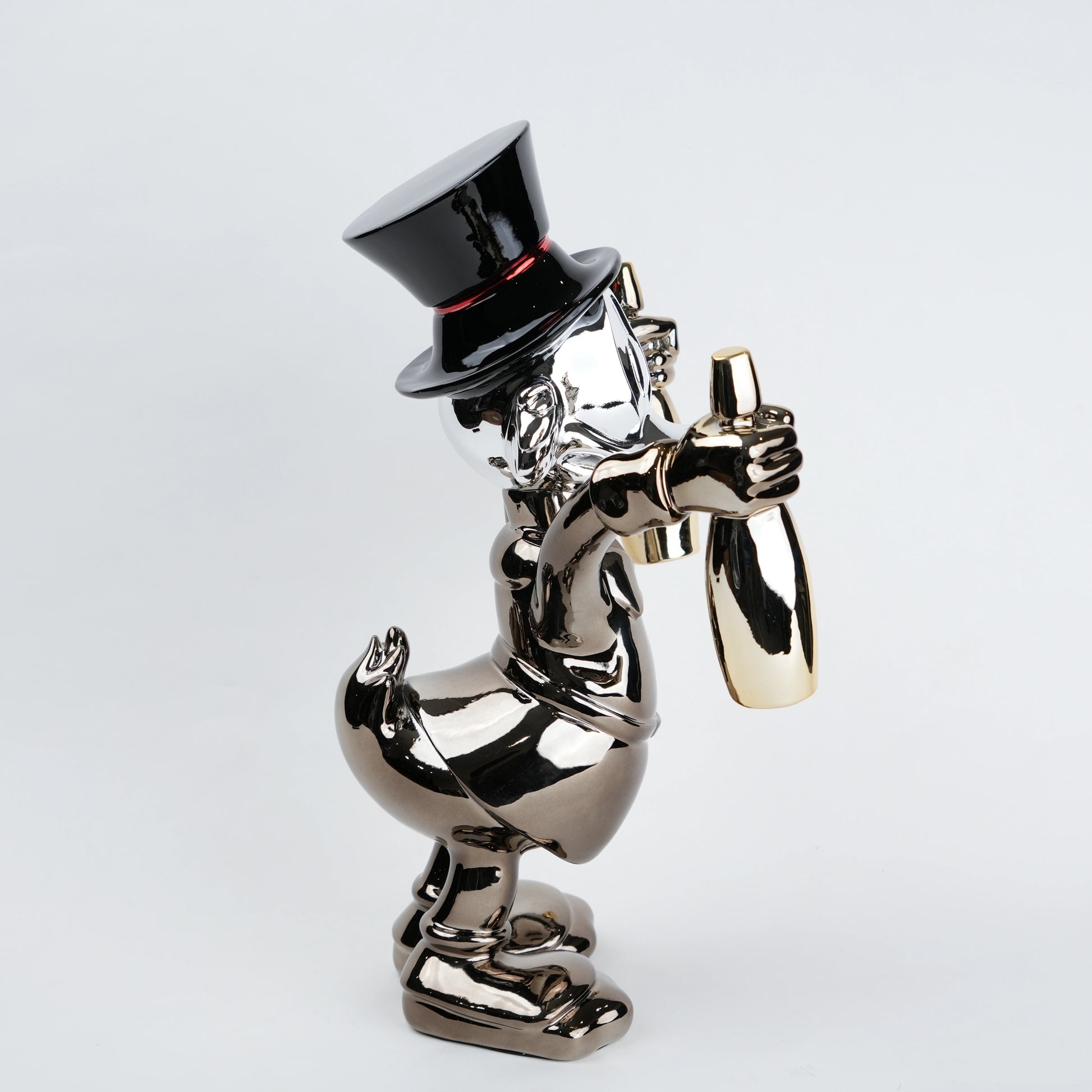 metallic duck figurine holding champagne bottles modern quirky home decor