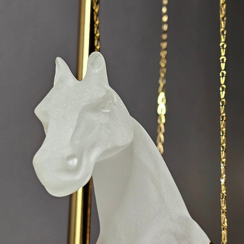 Gold galloping horse decor inside black frame tabletop display