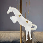 Gold galloping horse decor inside black frame tabletop display