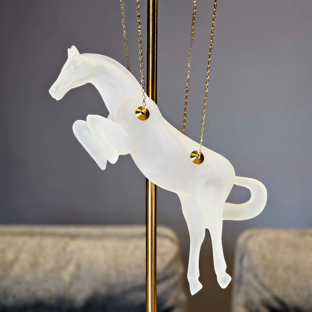 Gold galloping horse decor inside black frame tabletop display