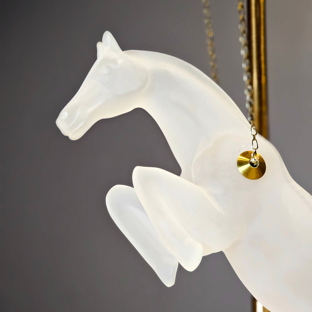 Gold galloping horse decor inside black frame tabletop display