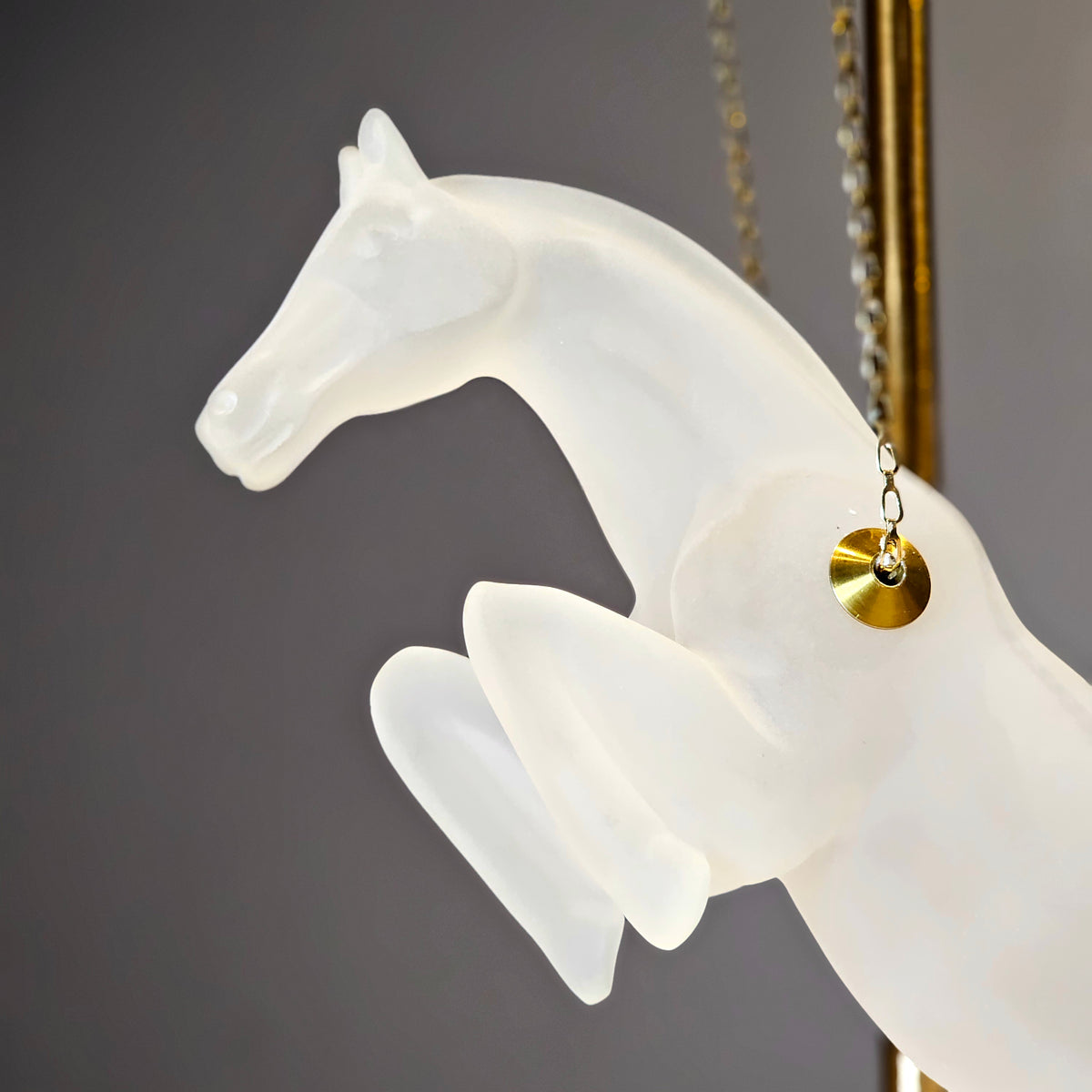 Gold galloping horse decor inside black frame tabletop display