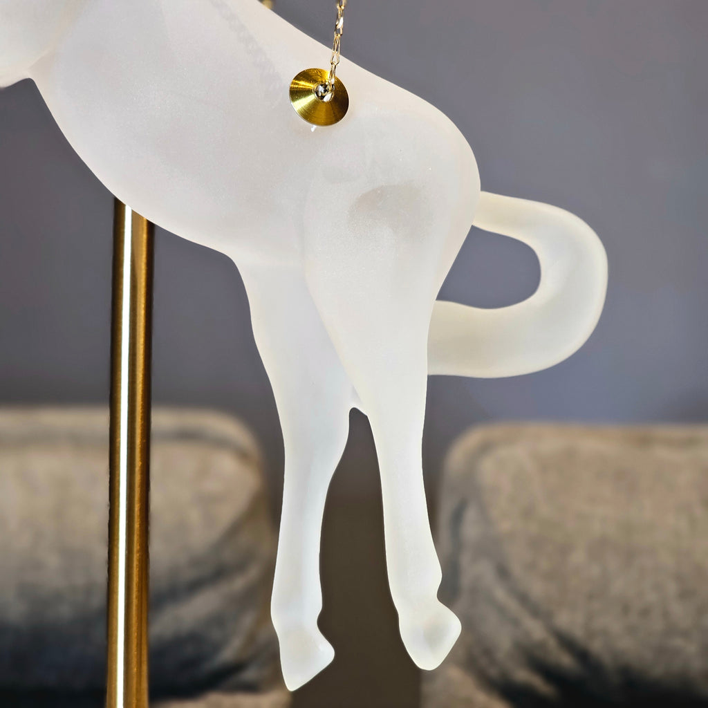 Gold galloping horse decor inside black frame tabletop display