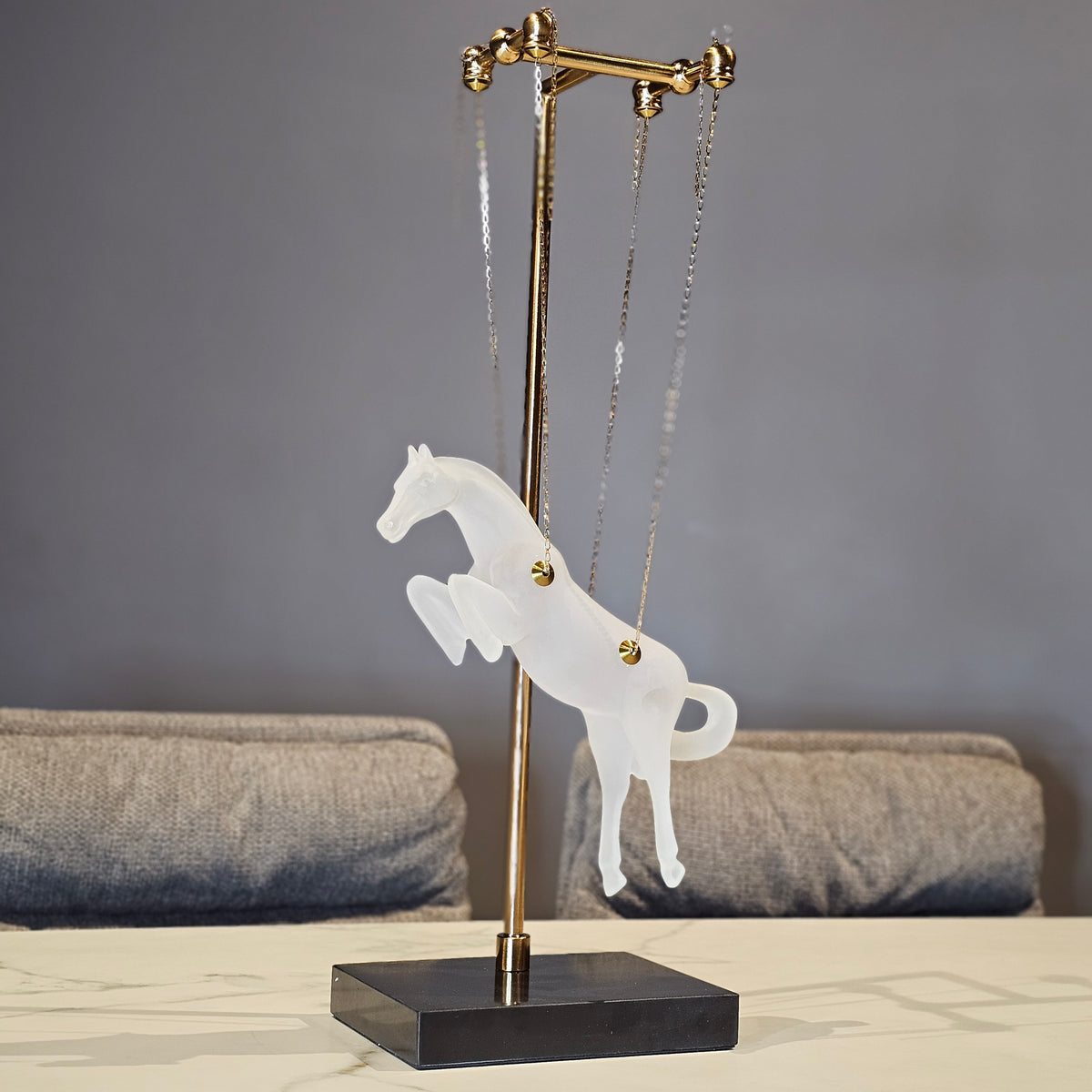 Gold galloping horse decor inside black frame tabletop display