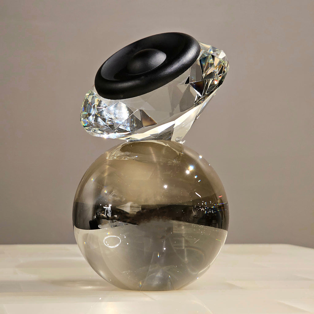 Luxury crystal decorative accent featuring a faceted crystal element balanced on a smoked crystal sphere with contemporary geometric styling, ideal for coffee tables, consoles, offices and modern designer interiors.