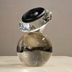Luxury crystal decorative accent featuring a faceted crystal element balanced on a smoked crystal sphere with contemporary geometric styling, ideal for coffee tables, consoles, offices and modern designer interiors.