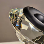 Luxury crystal decorative accent featuring a faceted crystal element balanced on a smoked crystal sphere with contemporary geometric styling, ideal for coffee tables, consoles, offices and modern designer interiors.