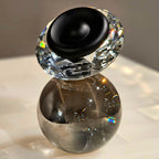 Luxury crystal decorative accent featuring a faceted crystal element balanced on a smoked crystal sphere with contemporary geometric styling, ideal for coffee tables, consoles, offices and modern designer interiors.