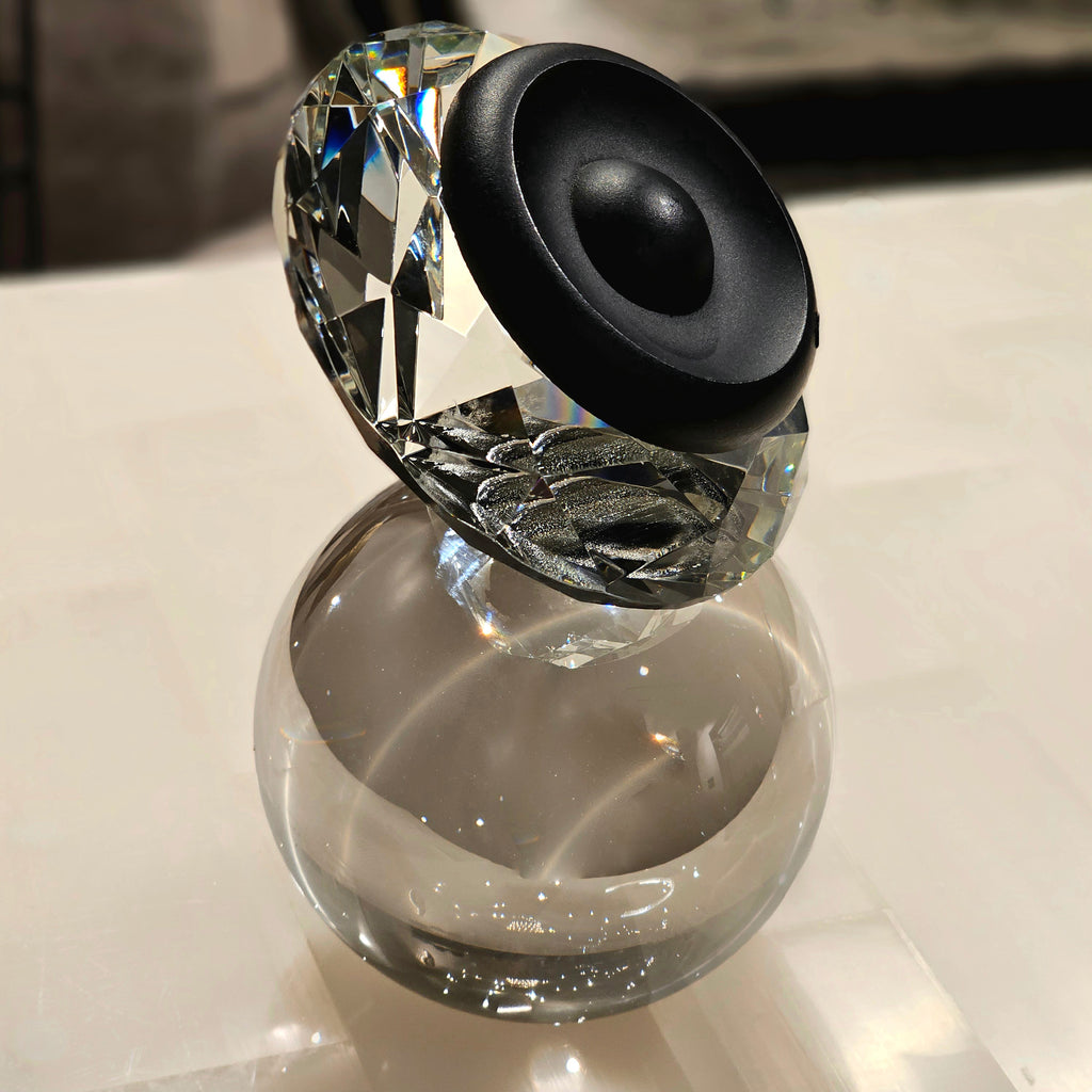 Luxury crystal decorative accent featuring a faceted crystal element balanced on a smoked crystal sphere with contemporary geometric styling, ideal for coffee tables, consoles, offices and modern designer interiors.