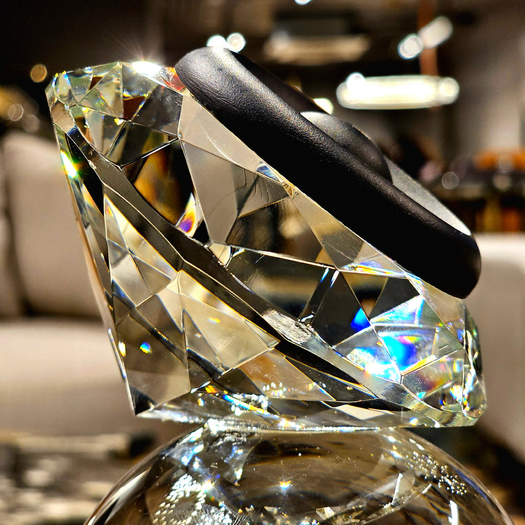 Luxury crystal decorative accent featuring a faceted crystal element balanced on a smoked crystal sphere with contemporary geometric styling, ideal for coffee tables, consoles, offices and modern designer interiors.