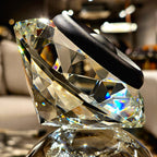 Luxury crystal decorative accent featuring a faceted crystal element balanced on a smoked crystal sphere with contemporary geometric styling, ideal for coffee tables, consoles, offices and modern designer interiors.