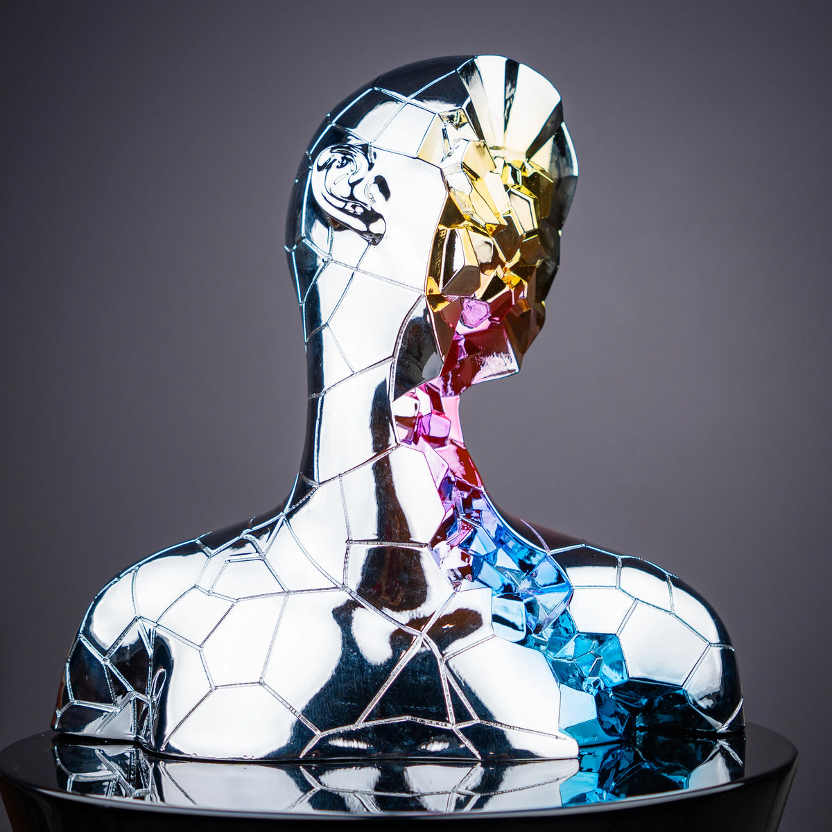 Modern prism face sculpture featuring chrome geometric detailing and vibrant artistic accents for elegant living room decor arrangements