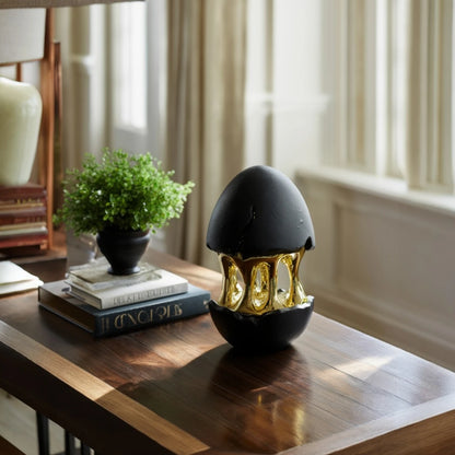 Contemporary abstract decor accent with black matte finish and gold detailing for stylish home interiors