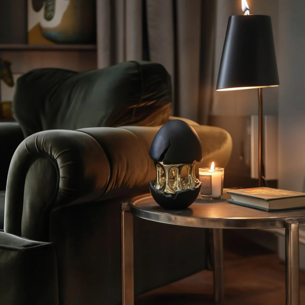 Gilded core egg by candle & dark lamp