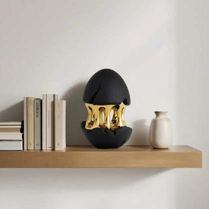 Gilded core egg on oak shelf w/ books