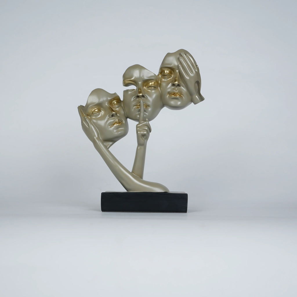 Gold abstract triple-face sculpture on black base