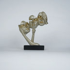 Gold abstract triple-face sculpture on black base