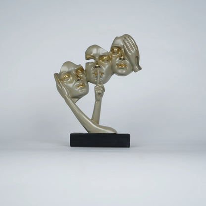 Gold abstract triple-face sculpture on black base