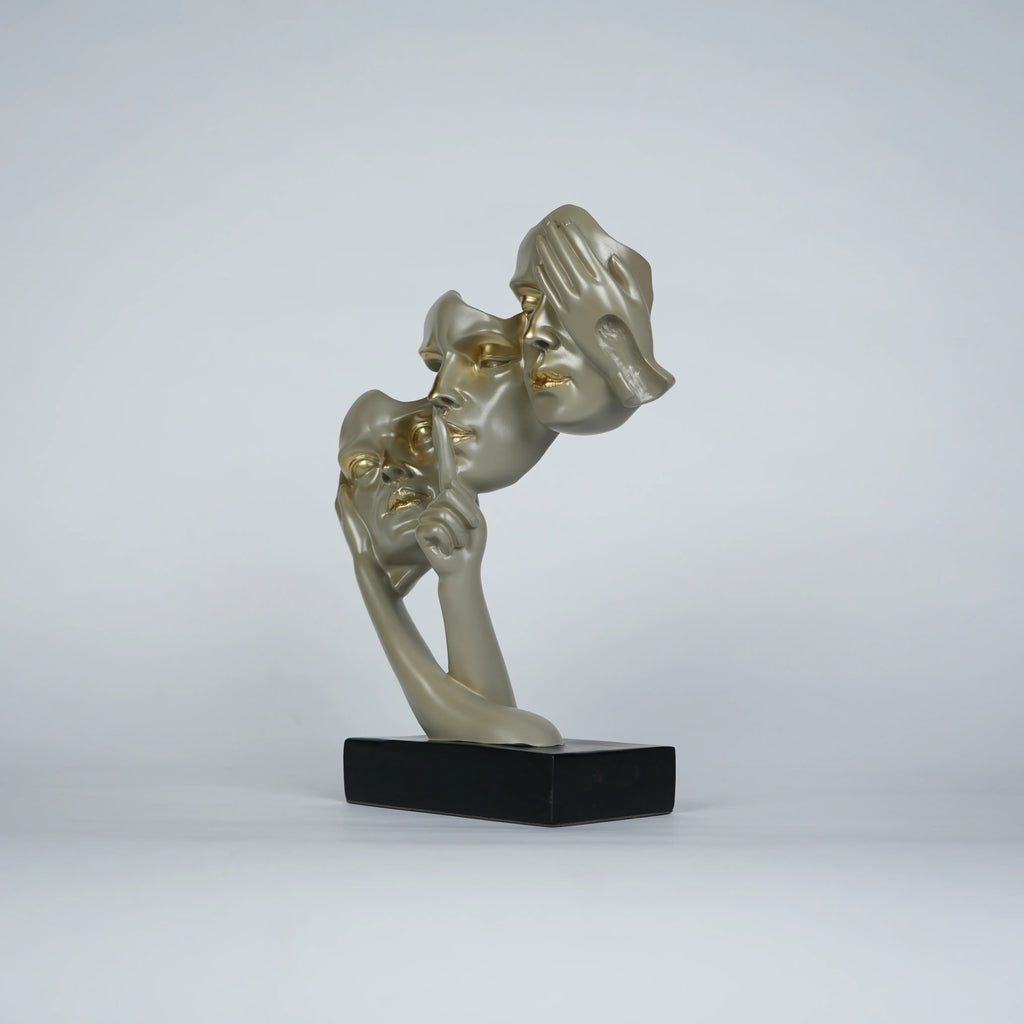 Gold abstract triple-face sculpture on black base