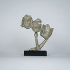 Gold abstract triple-face sculpture on black base