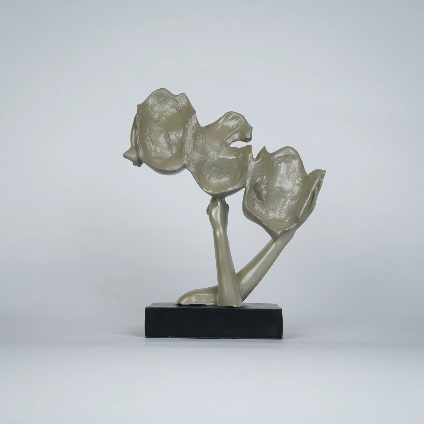 Gold abstract triple-face sculpture on black base