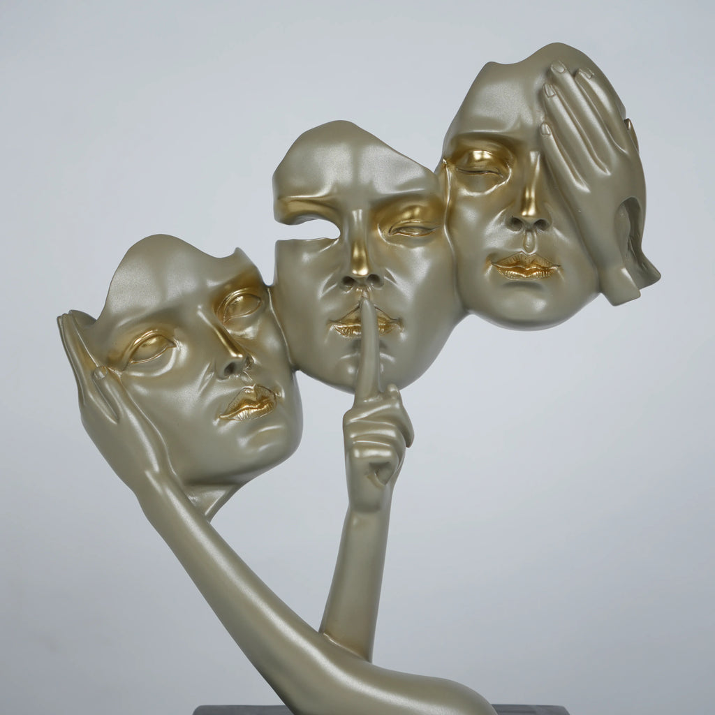 Gold abstract triple-face sculpture on black base