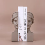 Decorative resin bookends featuring classical bust designs in a soft neutral finish.