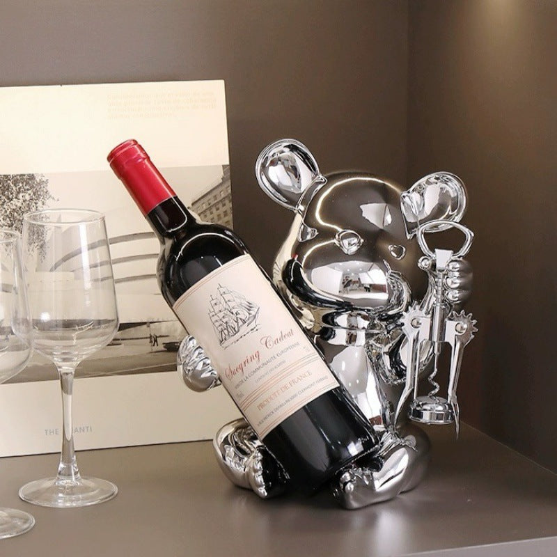 Luxury bear wine bottle holder featuring a chrome finish with an integrated corkscrew, designed to display wine bottles while adding elegance to home bars, dining rooms and contemporary interiors.