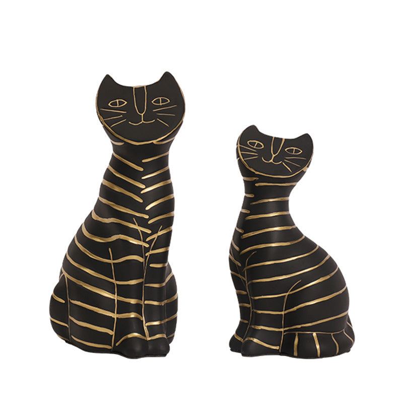 Decorative black cat figurine set with artistic gold line accents.