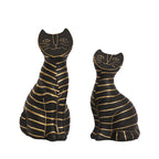 Decorative black cat figurine set with artistic gold line accents.