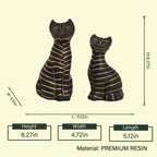 Decorative black cat figurine set with artistic gold line accents.