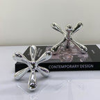 Artistic chrome decor objects with abstract contemporary design for elegant modern interiors