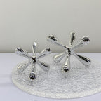 Contemporary chrome tabletop decor featuring abstract geometric artistic form and reflective finish