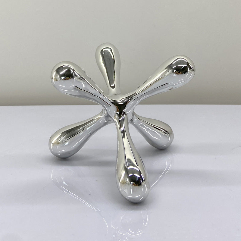 Artistic chrome decor objects with abstract contemporary design for elegant modern interiors