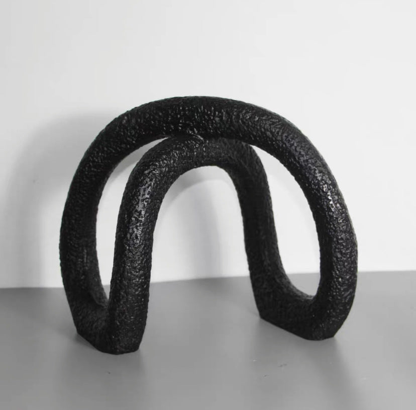 Black infinity loop decor with textured matte finish for modern interiors