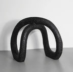 Black infinity loop decor with textured matte finish for modern interiors