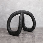Black infinity loop decor with textured matte finish for modern interiors