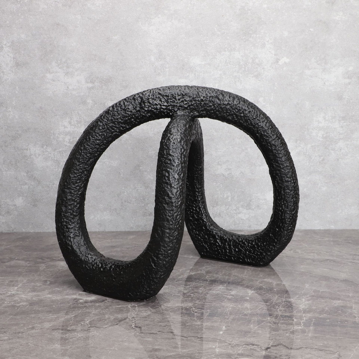 Black infinity loop decor with textured matte finish for modern interiors