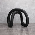 Black infinity loop on grey marble