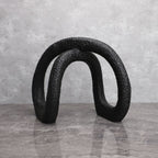 Black infinity loop on grey marble