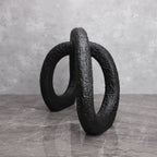 Black infinity loop decor with textured matte finish for modern interiors
